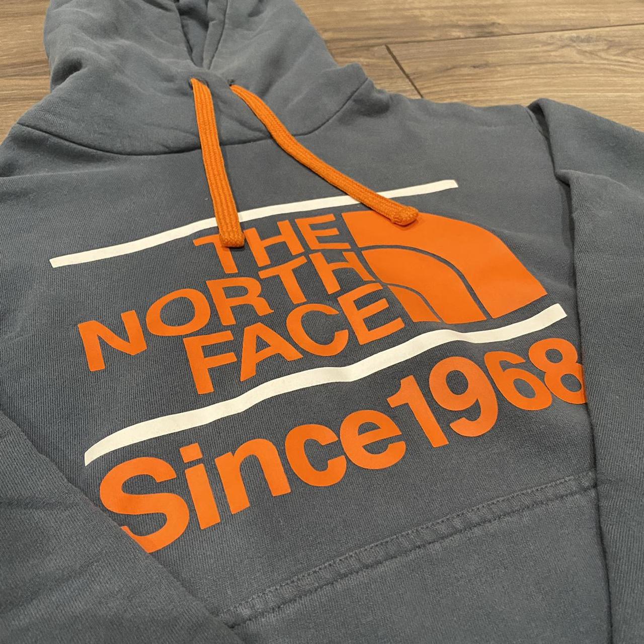 grey and orange north face hoodie