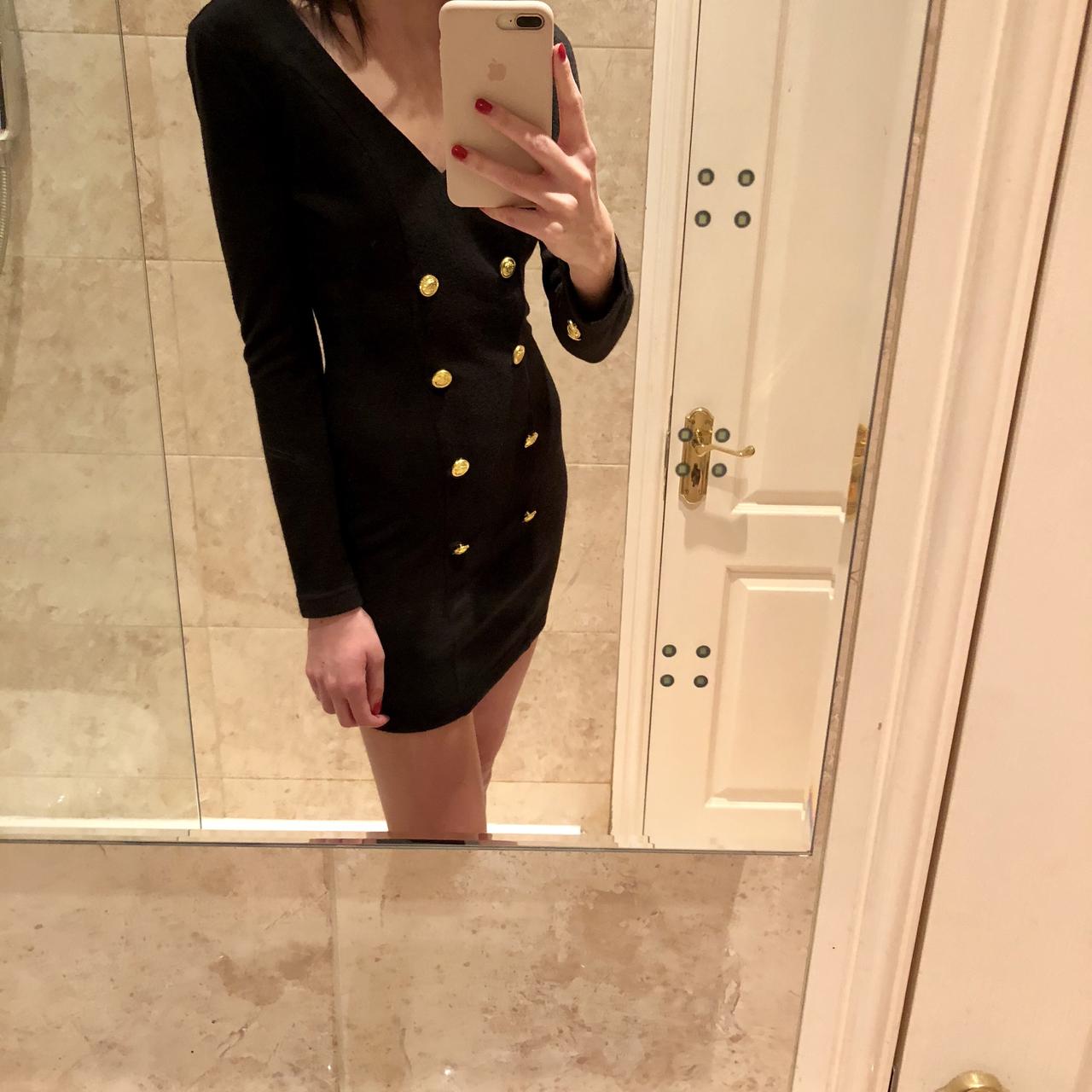 black dress with gold buttons down the front