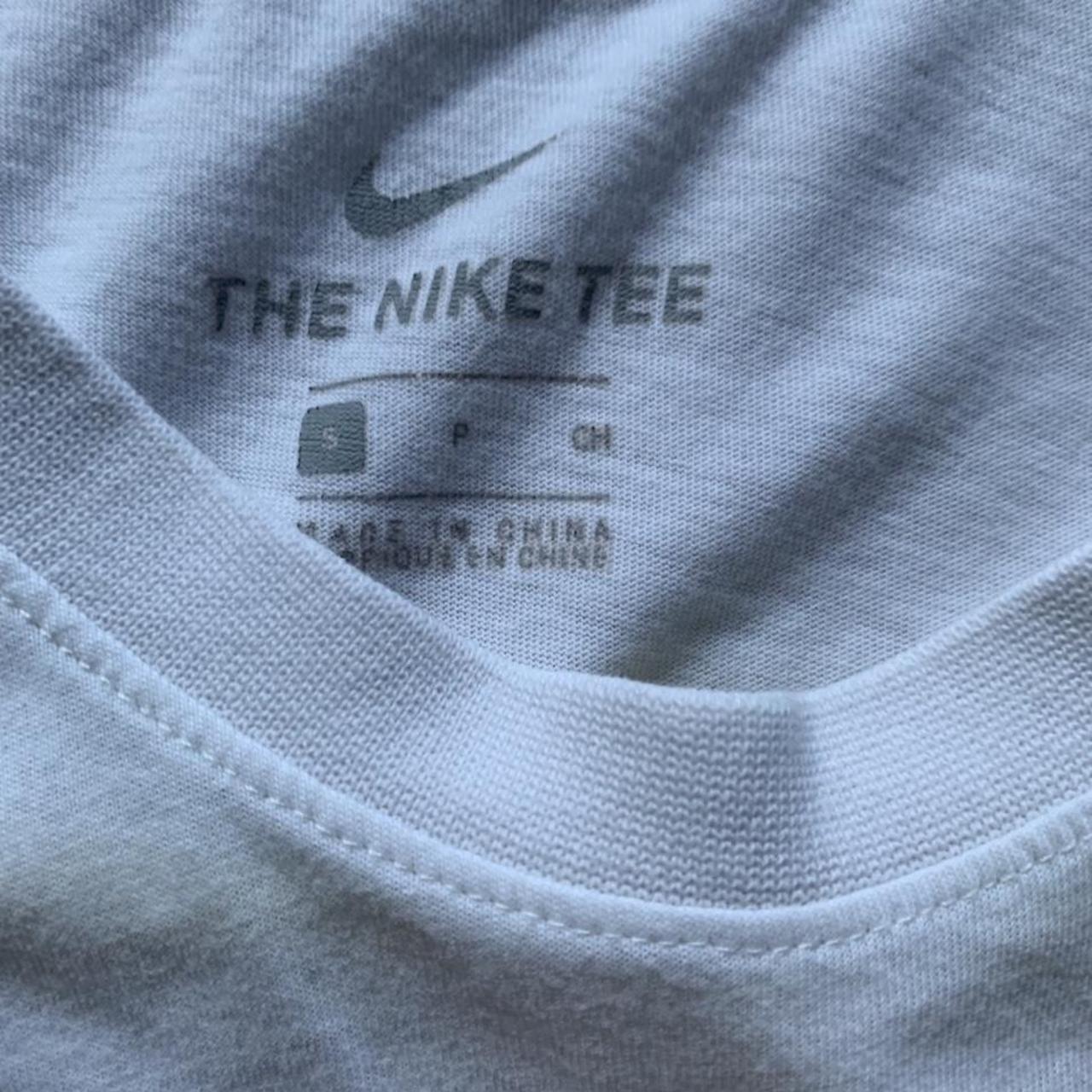 white nike shirt with orange logo