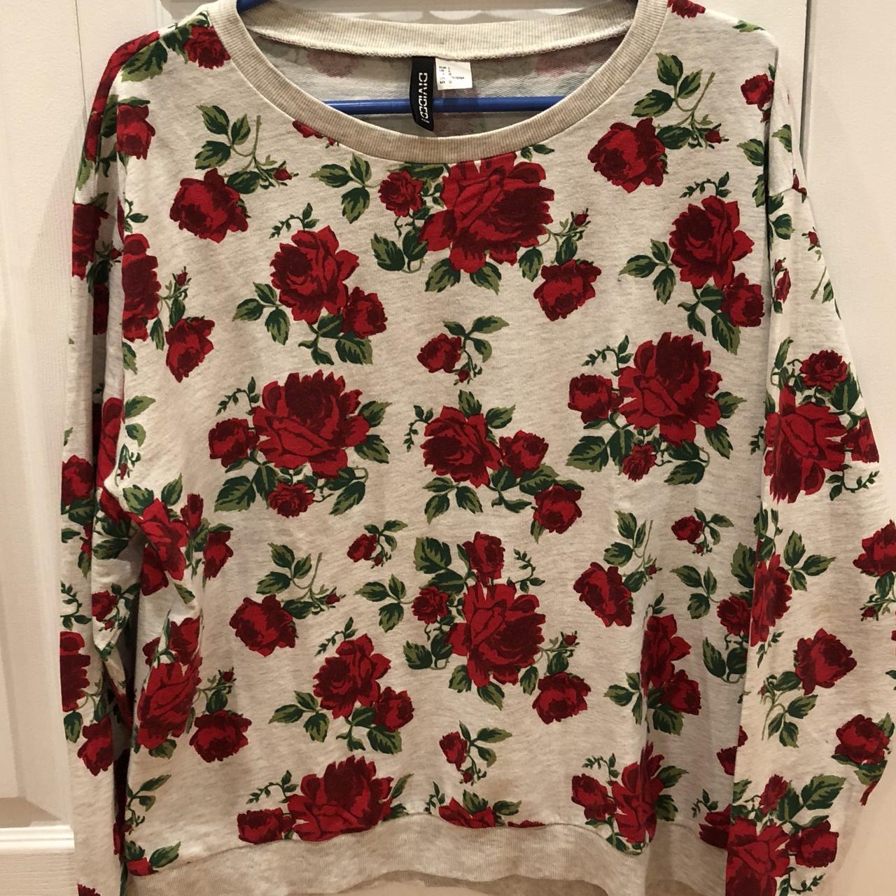 white sweater with red roses