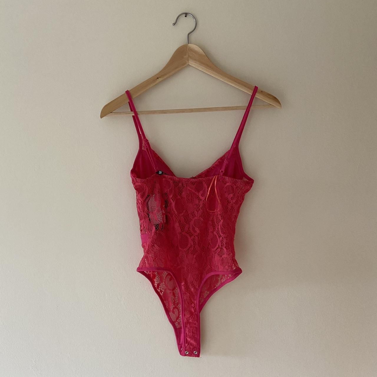 Bright pink lace thong bodysuit from in the... - Depop