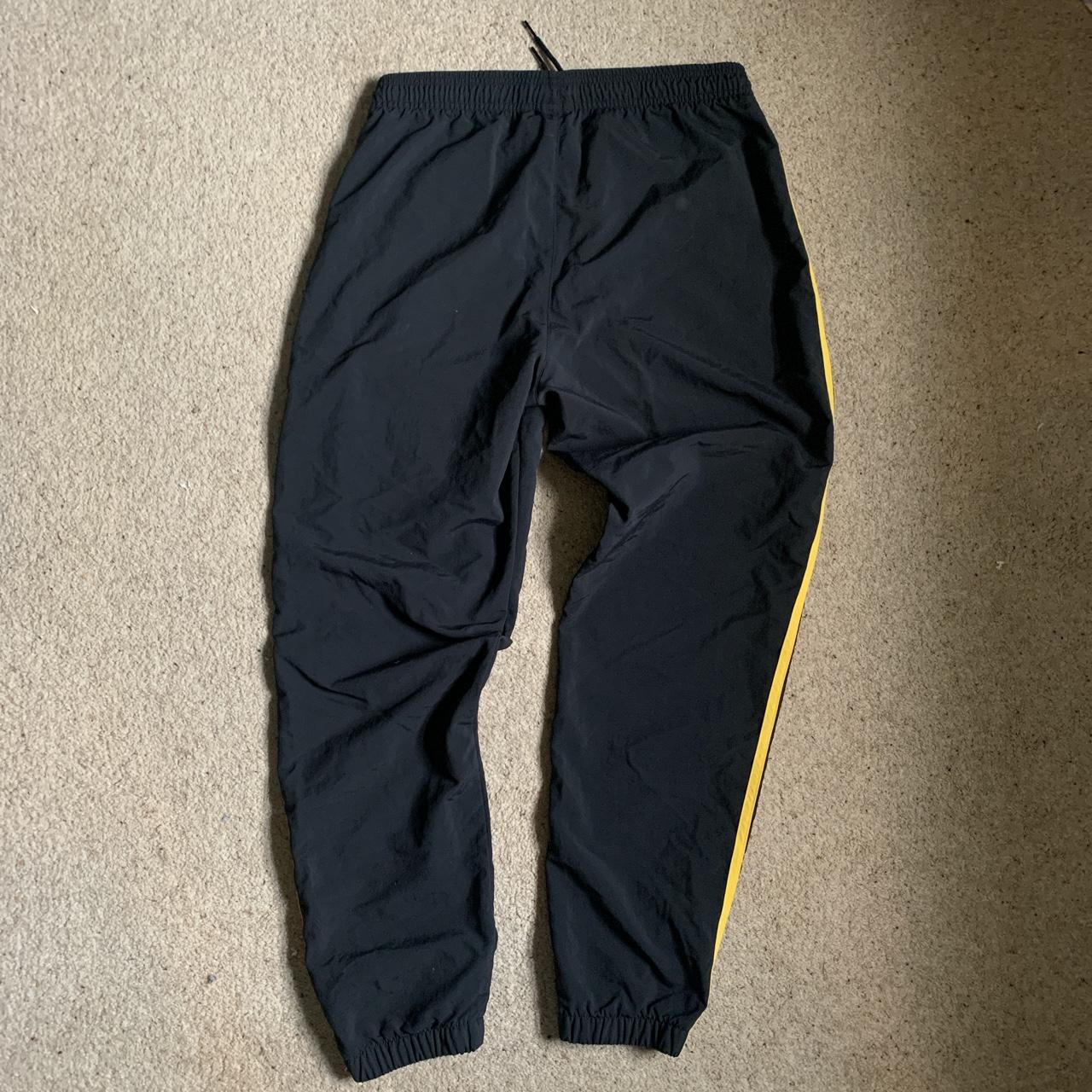 Adidas originals nylon track pants Black/yellow... - Depop