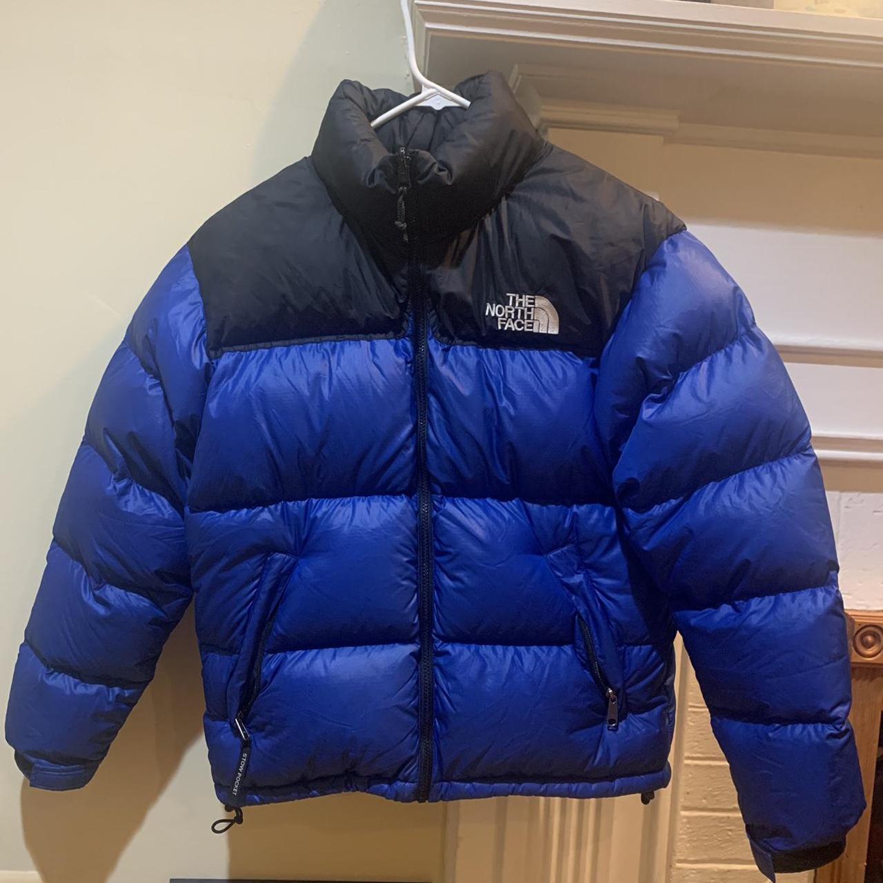 dark blue and black north face puffer