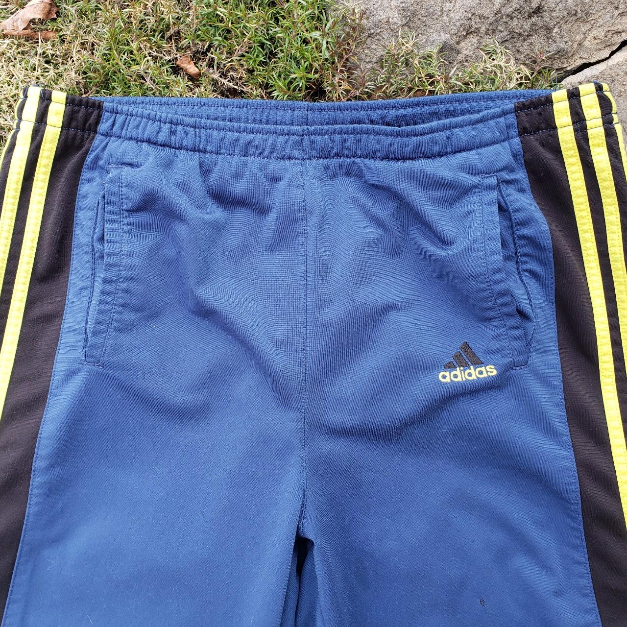 These Vintage 90s Adidas track pants with the snap...