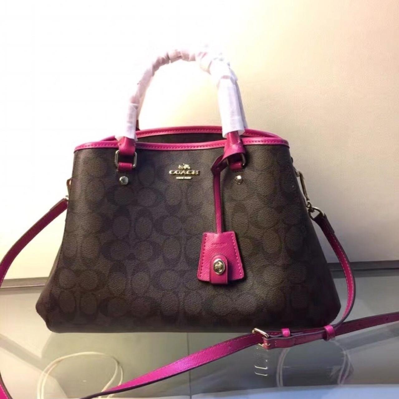 Dark brown coach handbag. Bag has pink strap & pink