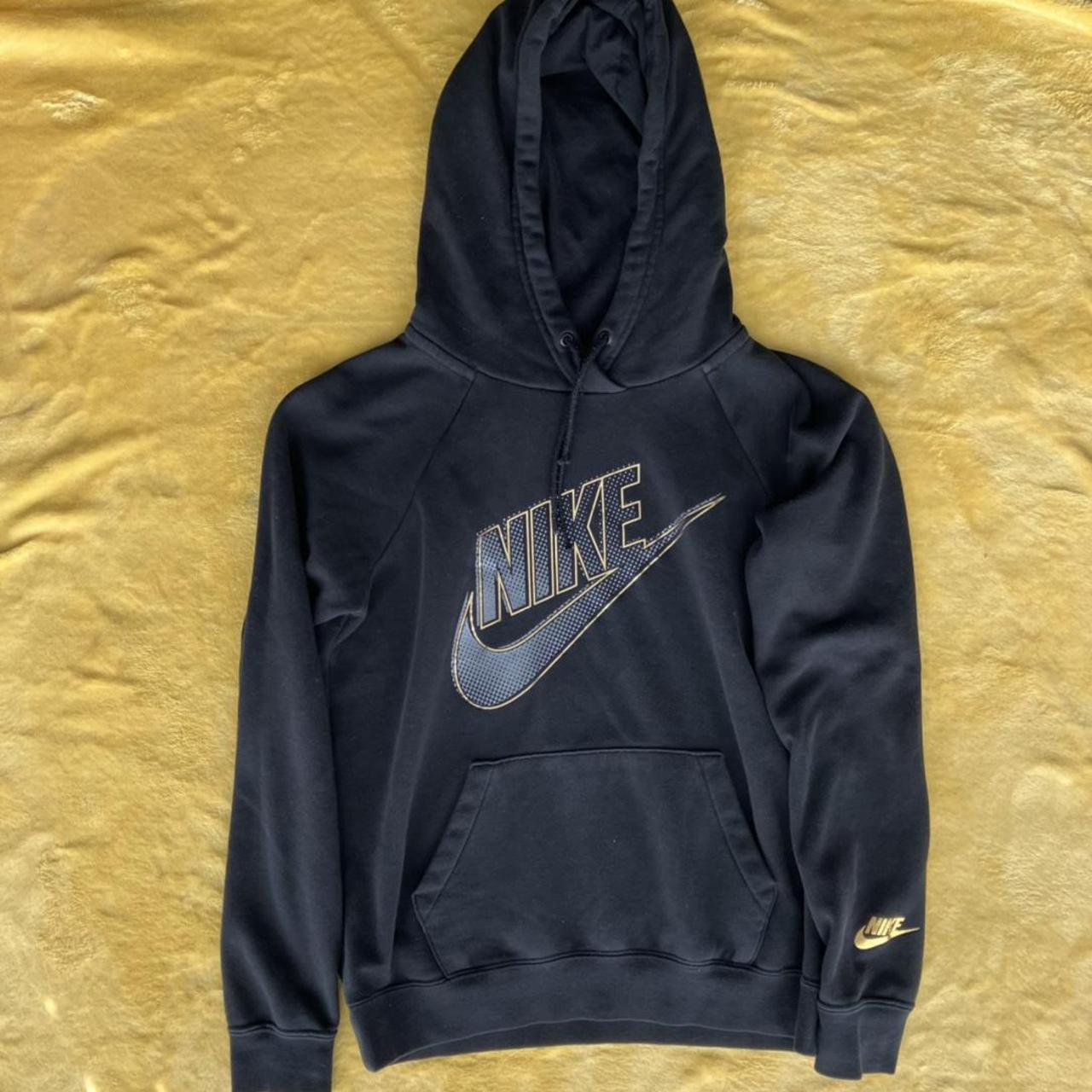 Nike hoodie in black with gold design. Size XS, good... - Depop