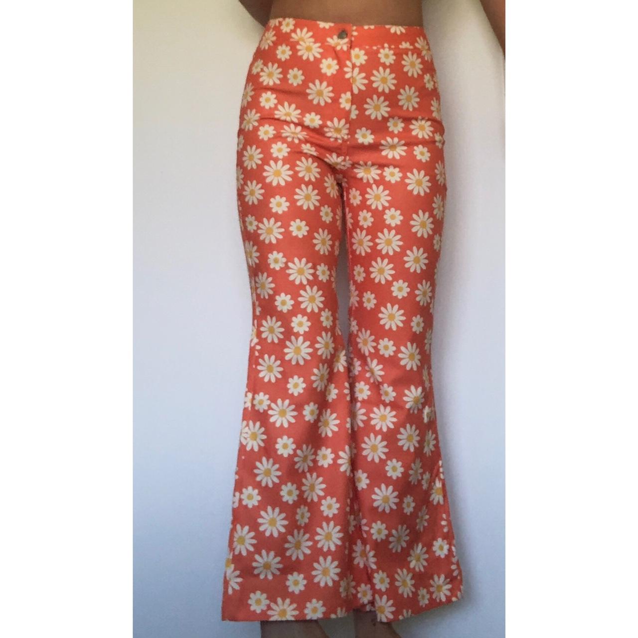 Very funky orange and daisy print flare pants. Have... - Depop