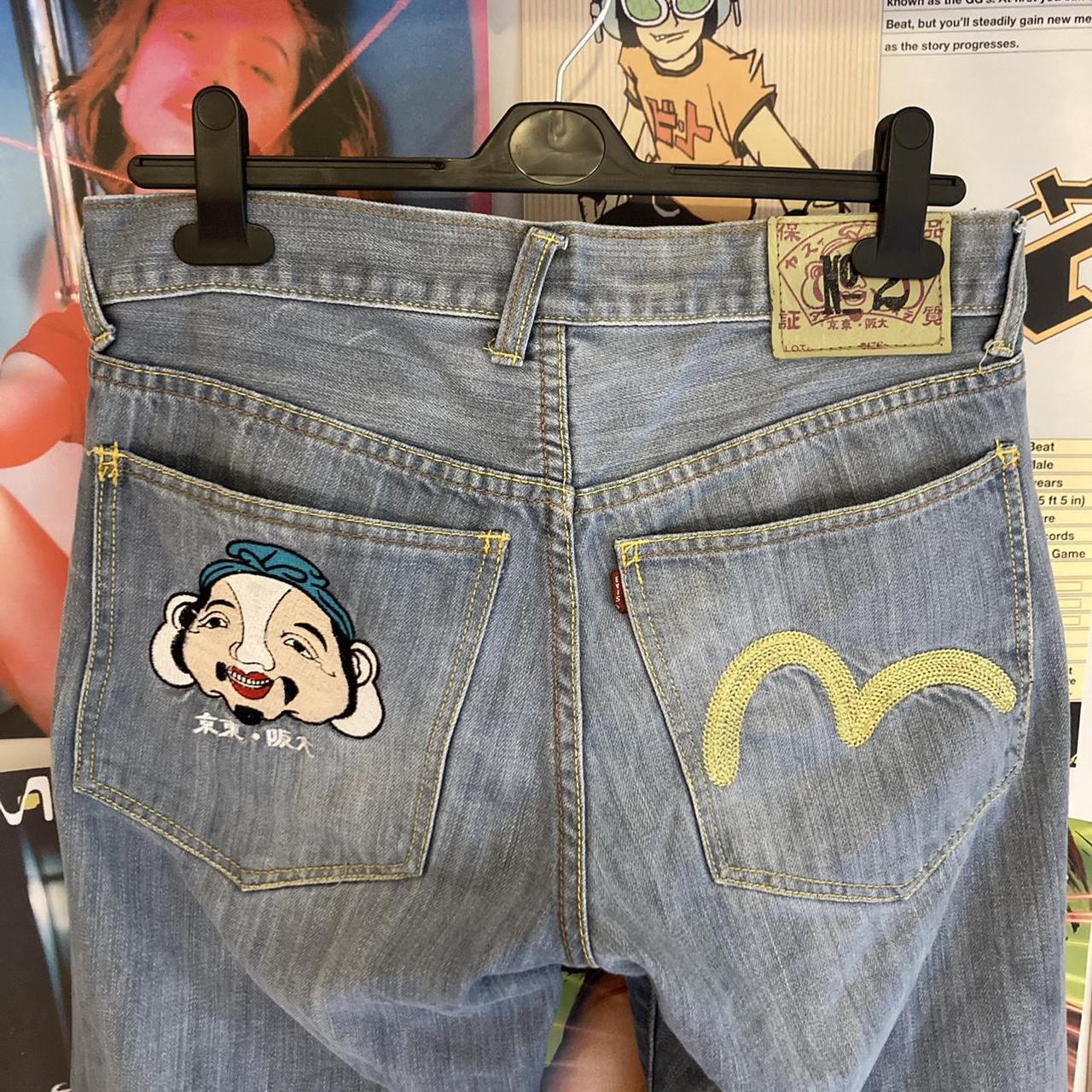 Evisu baggy light blue jeans. Face design and gold... - Depop