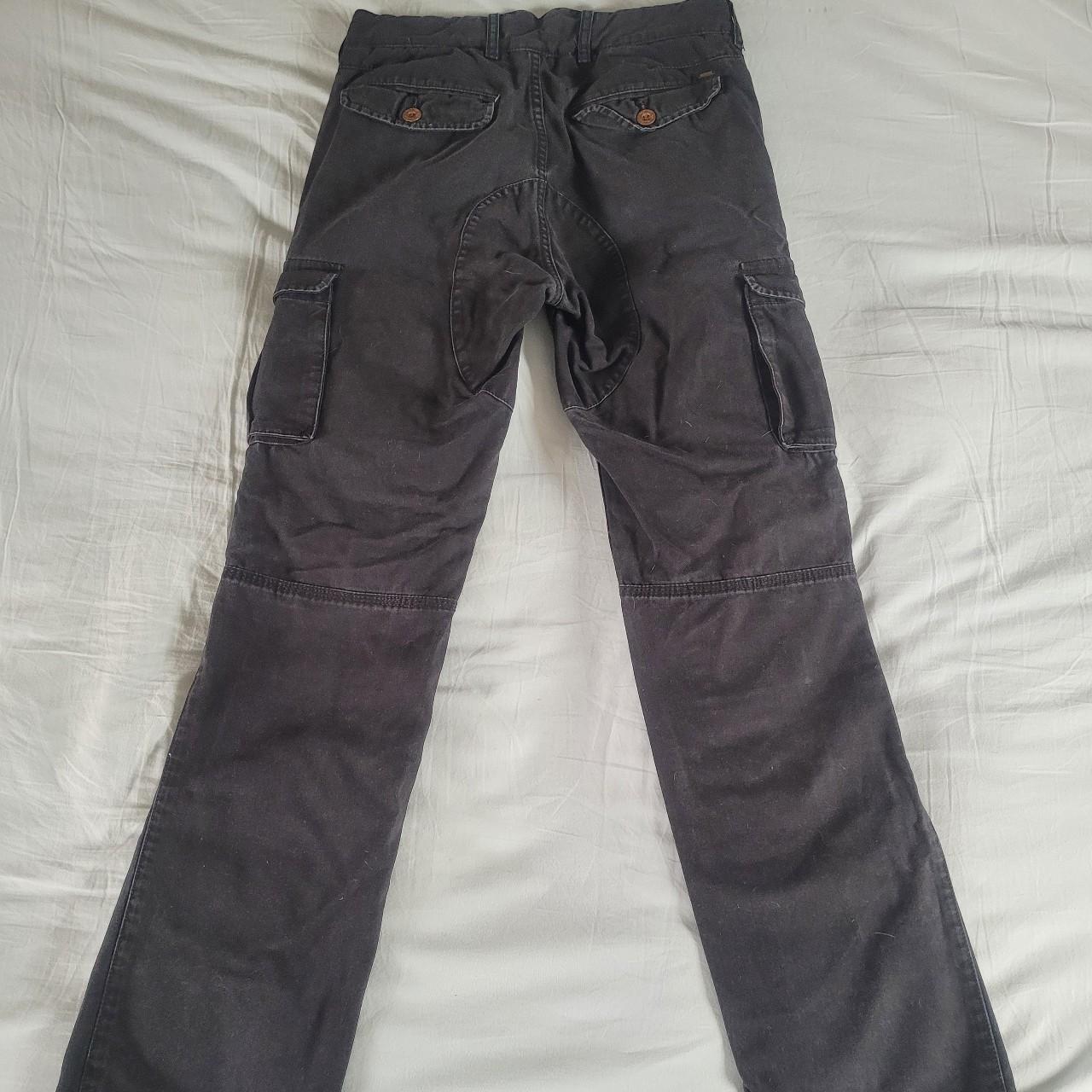 Low waisted black cargo trousers with a slim,... - Depop