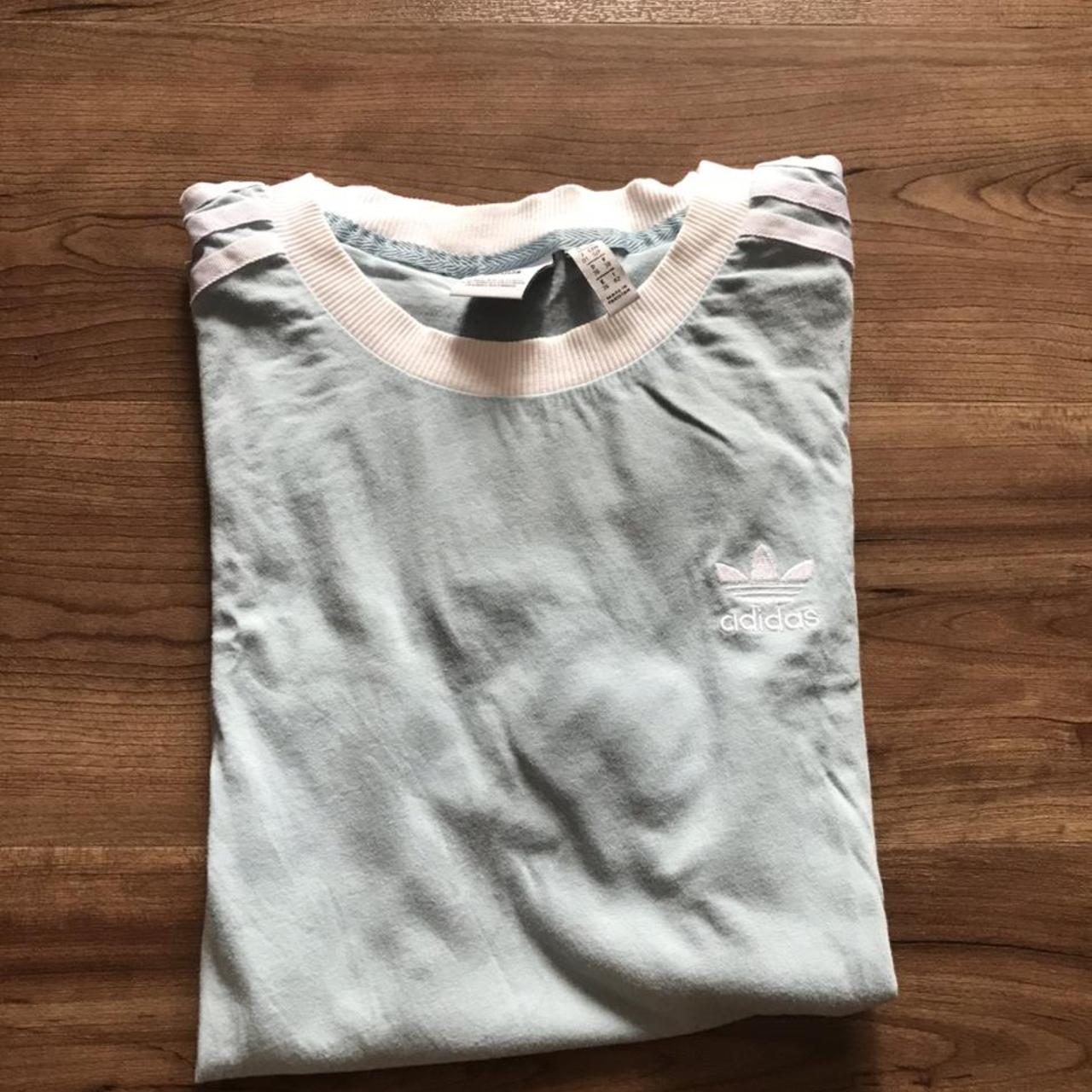 Baby blue adidas oversized tshirt. It says its a... Depop