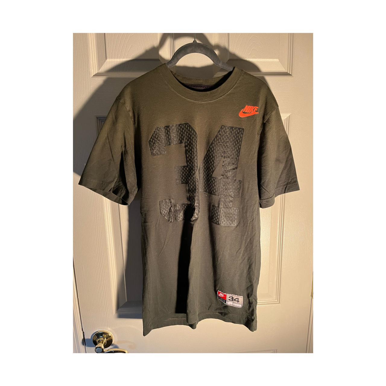 orange and olive green nike shirt