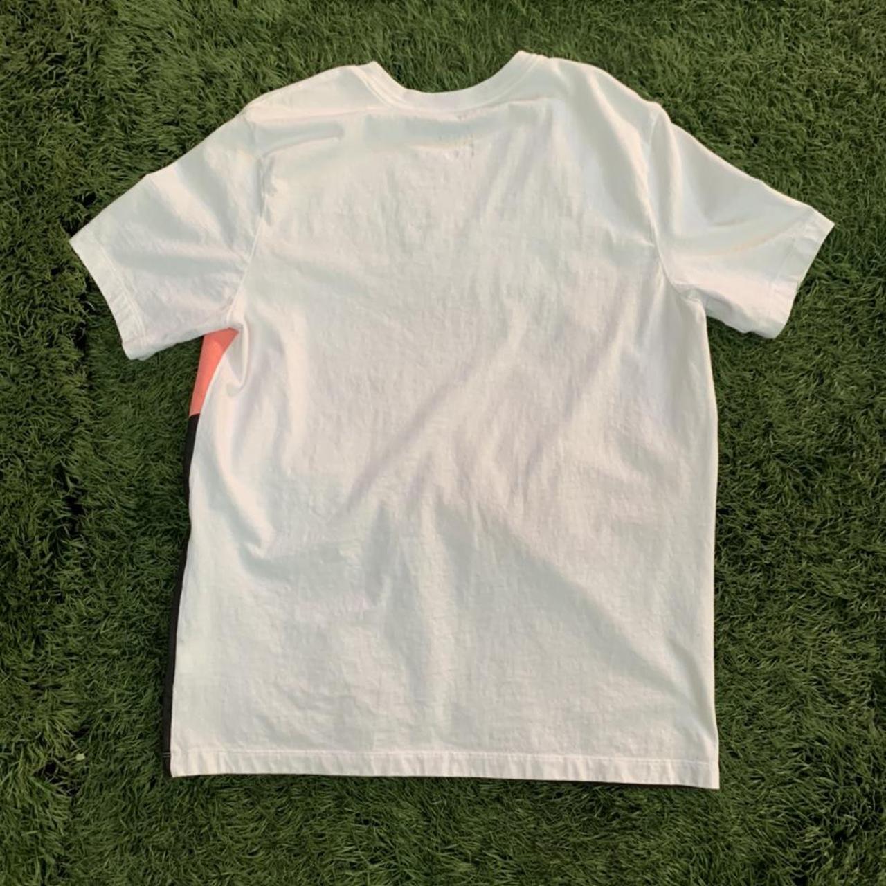 pink black and white nike shirt