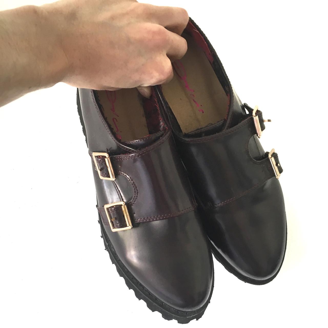 Burgundy creeper style monk shoes with gold buckles.... Depop