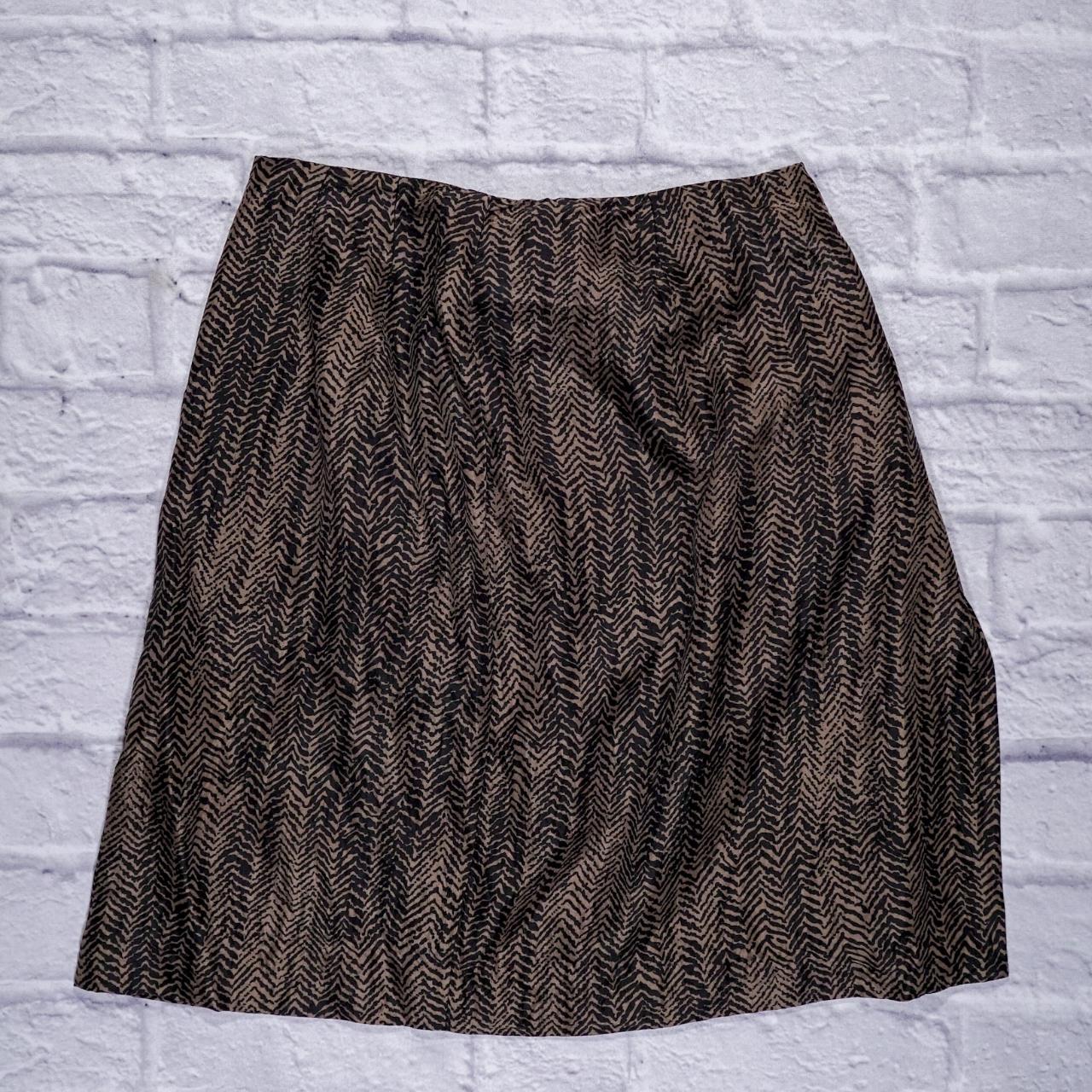 This is a silk black skirt with gold detail print.... - Depop