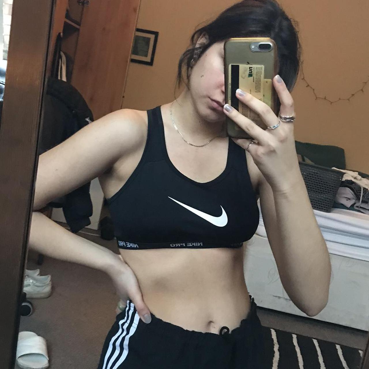 Nike black sports bra no padding so light support... Depop