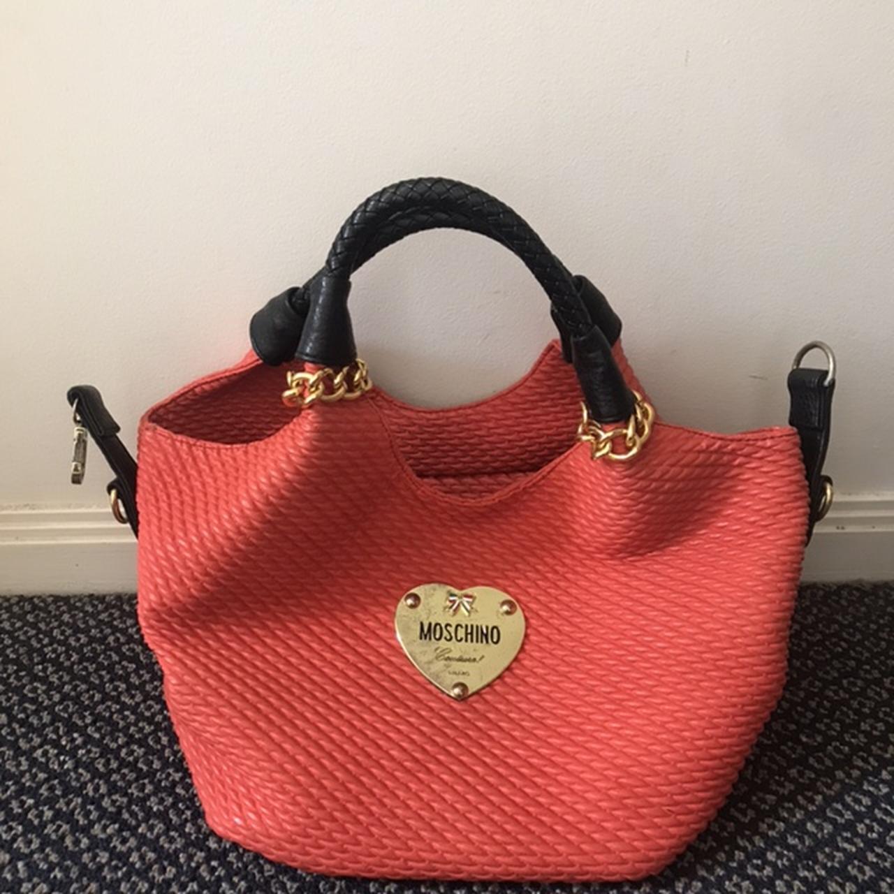 Orange moschino bag with black handles and gold... Depop
