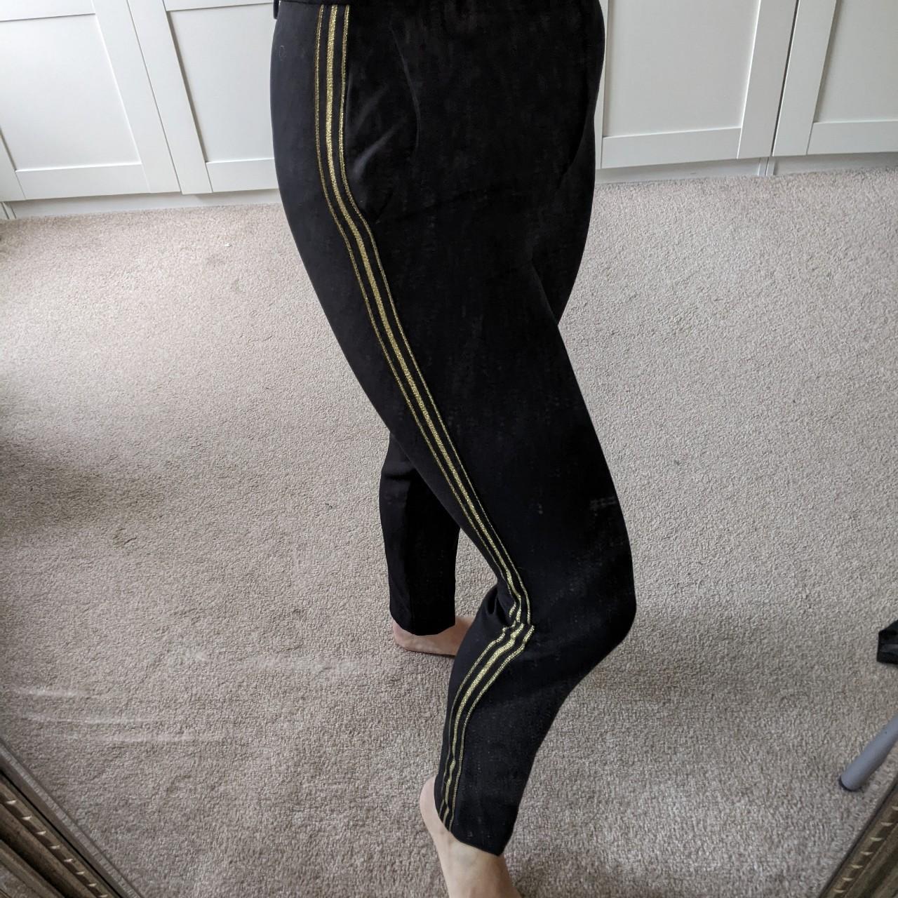 Black trousers store with gold stripe