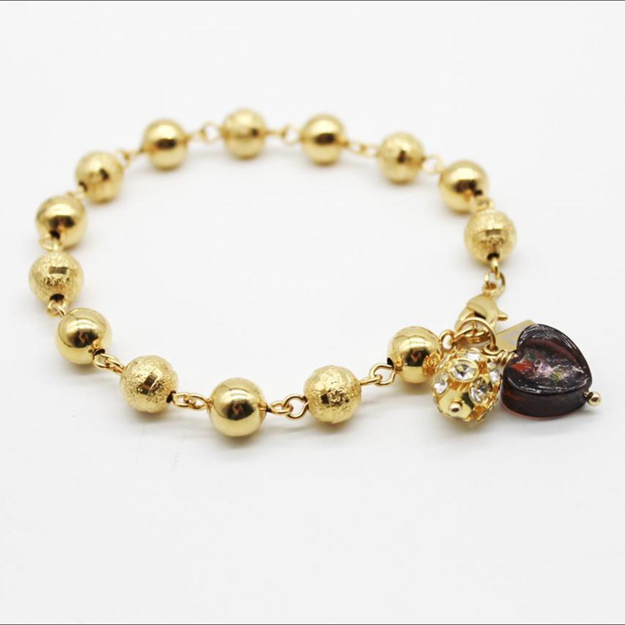 Gold bauble bracelet with glass heart and crystal... Depop