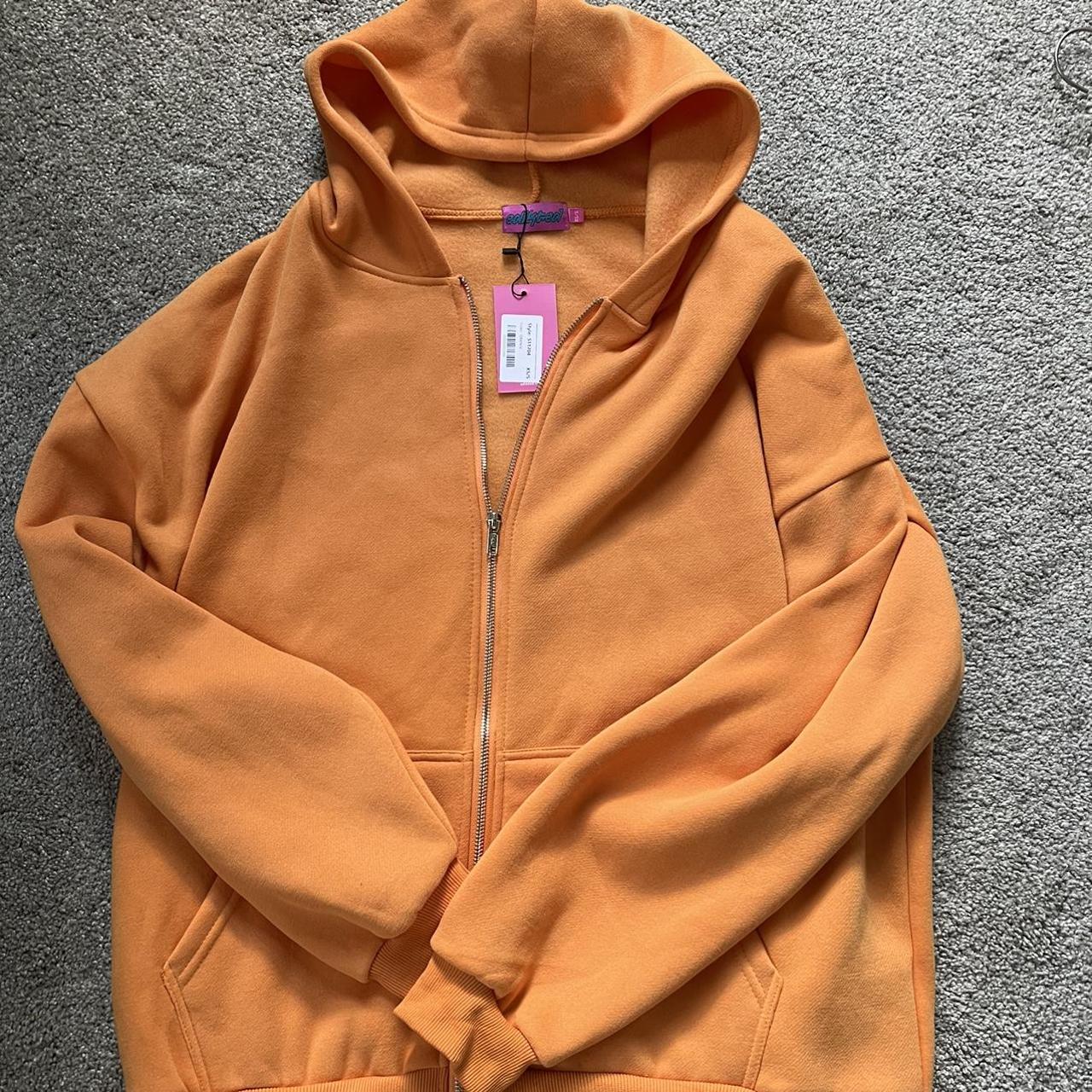 Never worn orange zip up hoodie Size XS/S but would... Depop