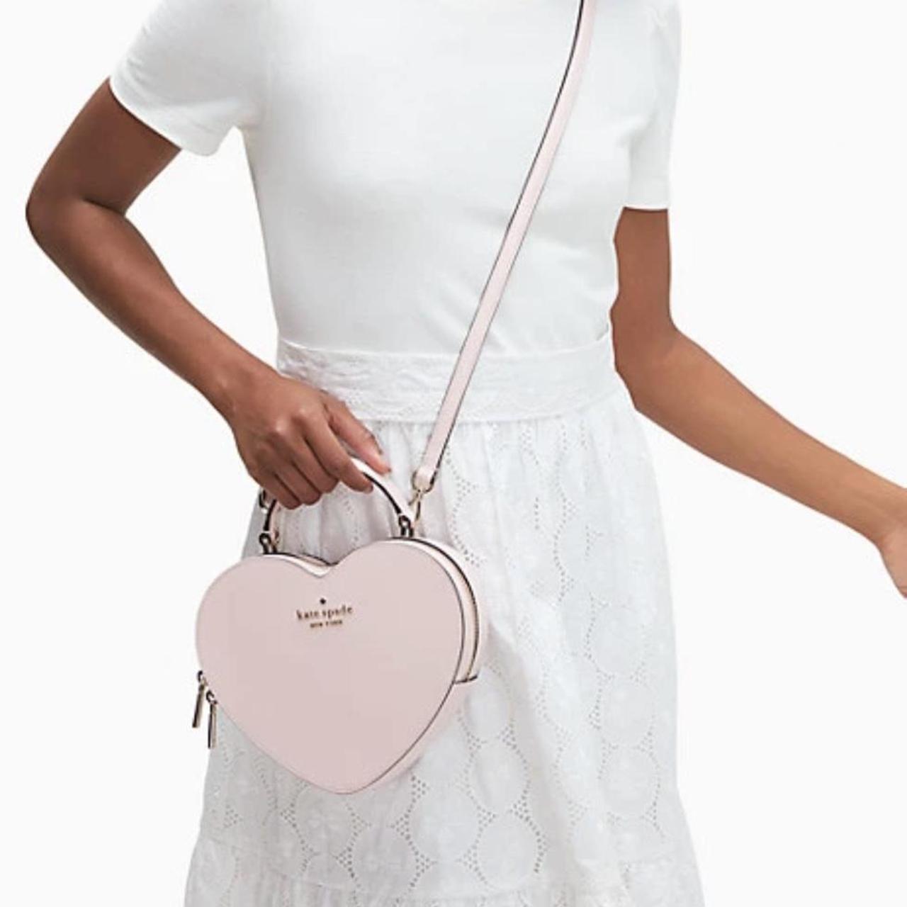 Light pink Kate Spade heart purse. Very spacious and