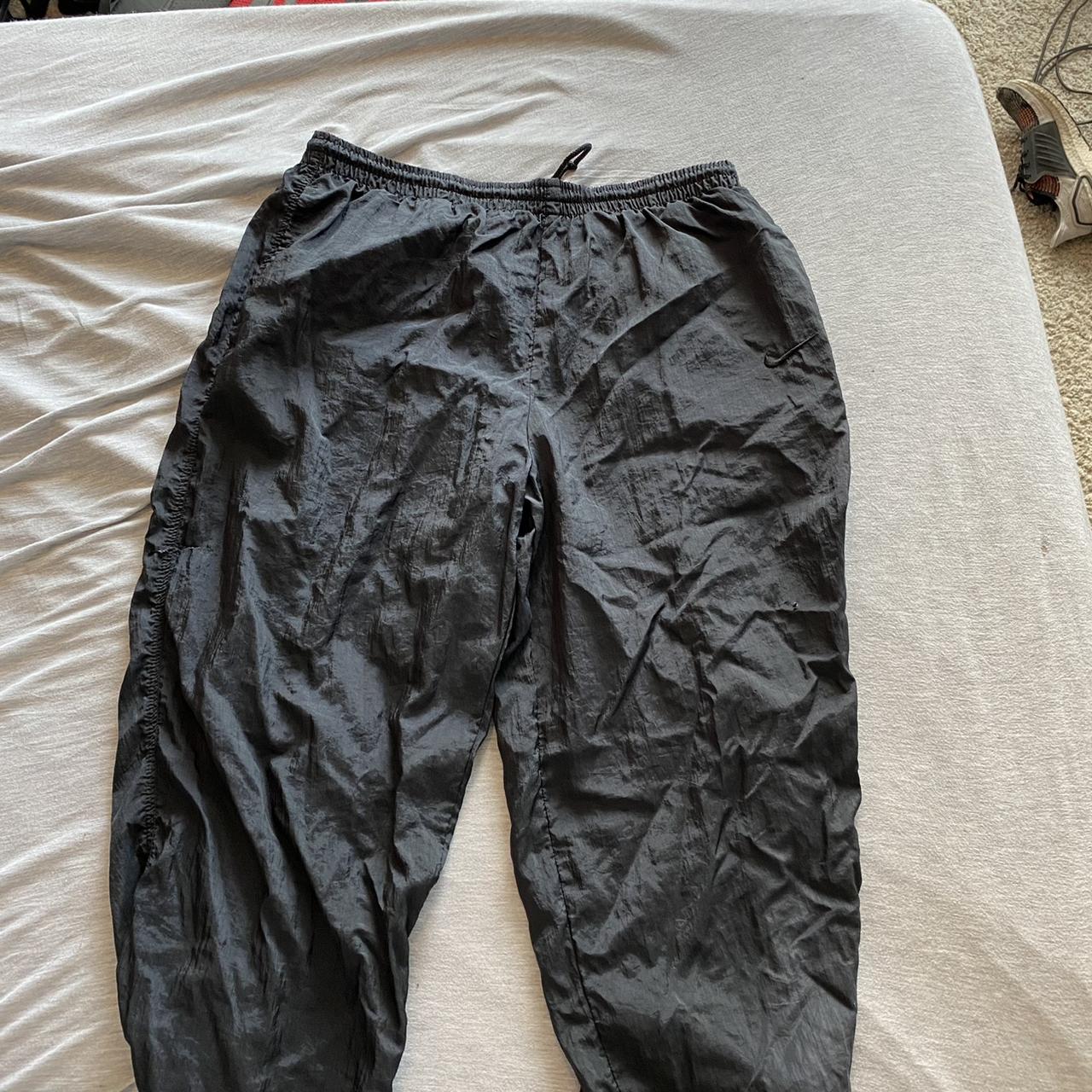 90s Nike sweatpants with seal holes and a tear Could... - Depop