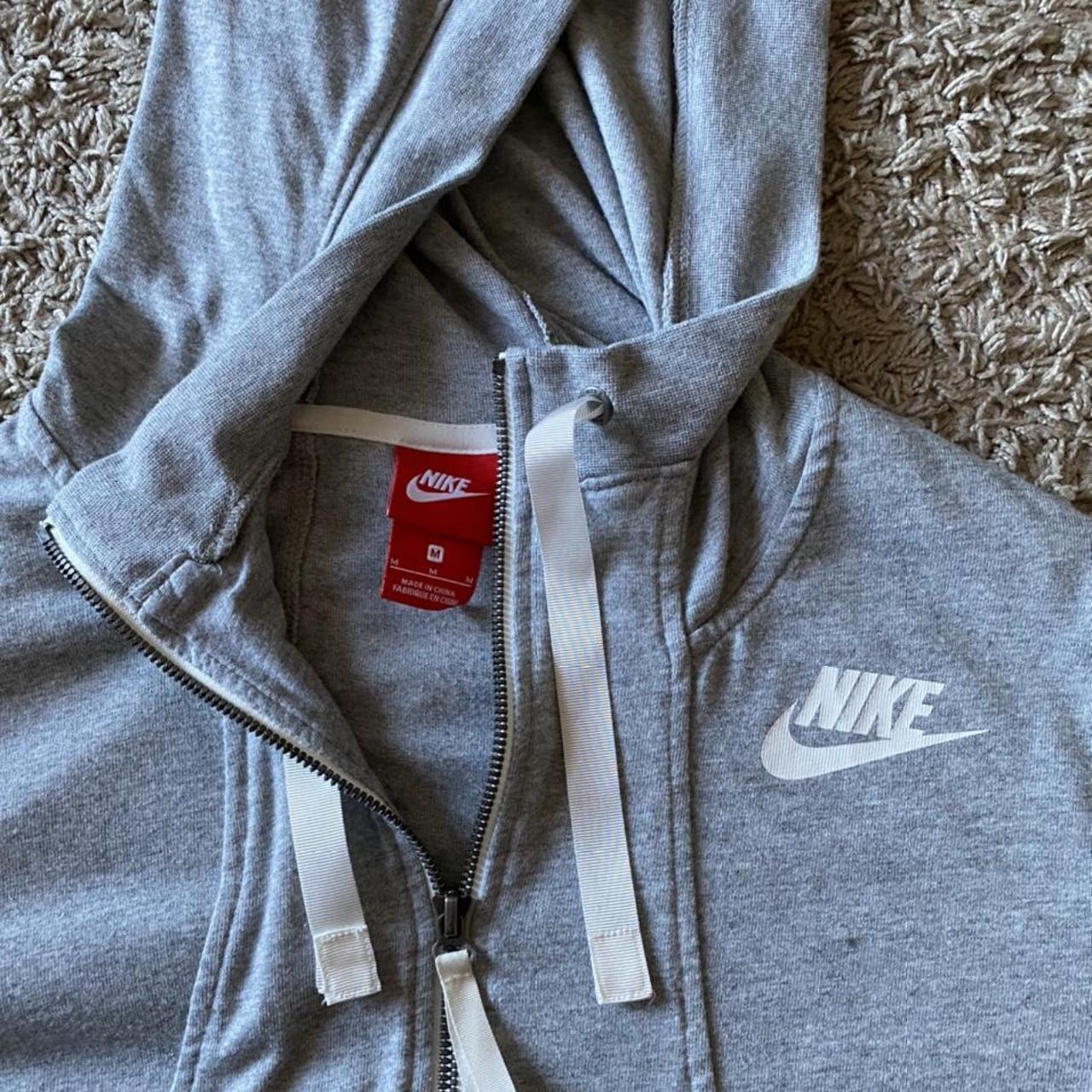 Nike grey zip up hoodie. High neck zip with white... - Depop