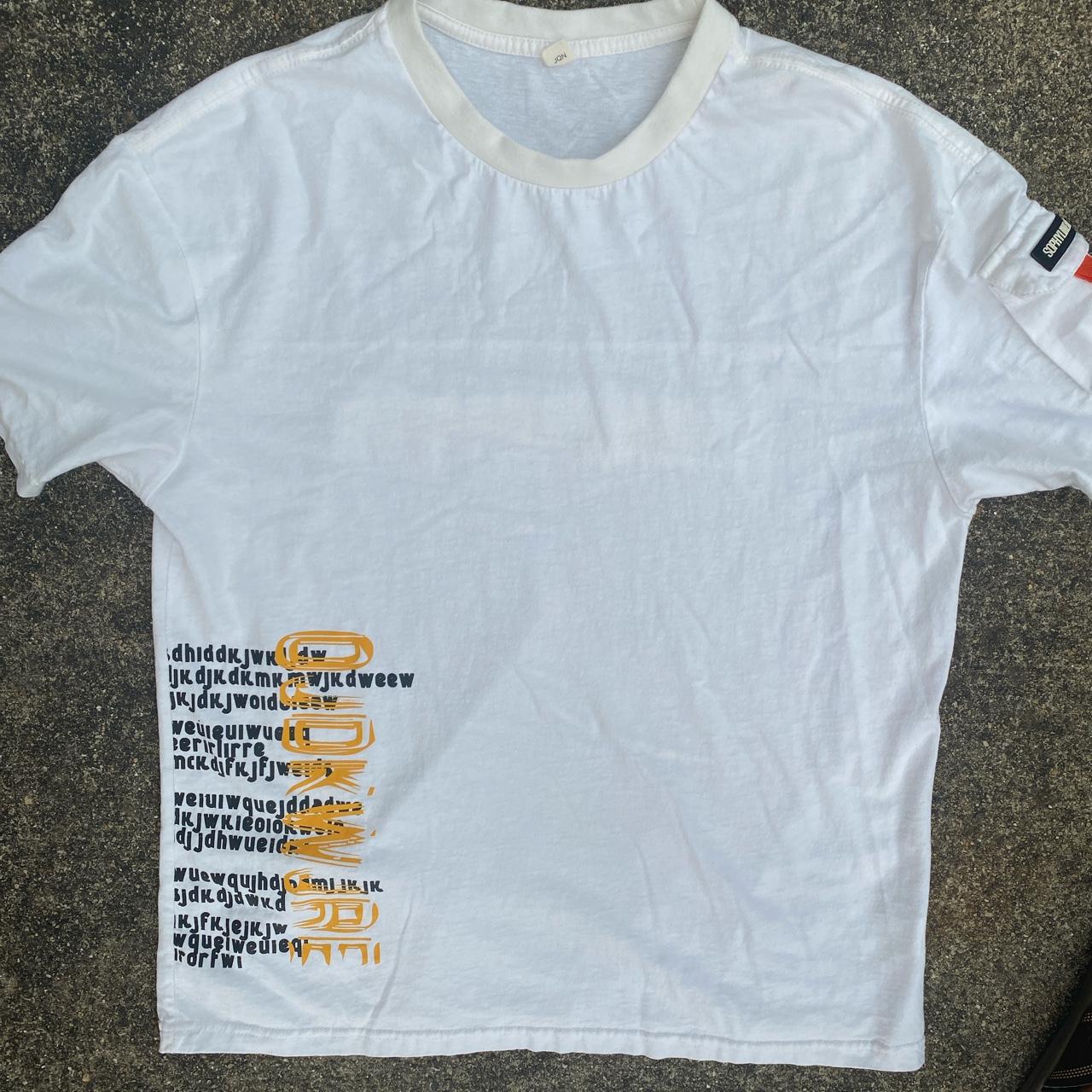 grey shirt with yellow writing