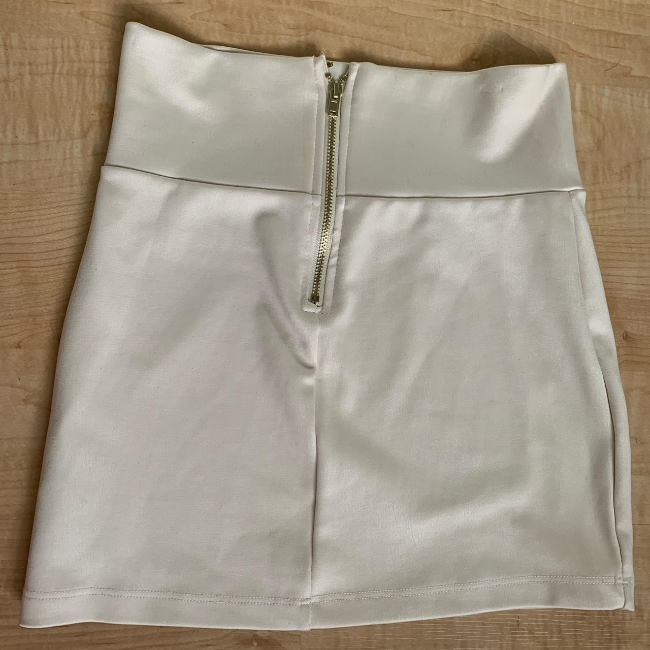 BEBE Cream silky mini skirt with gold details... - Depop