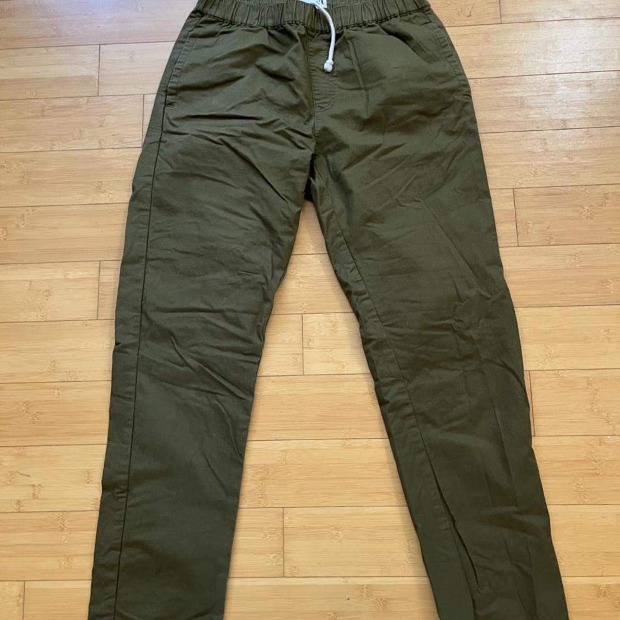 Green Pact pants with yellow stripe on... - Depop