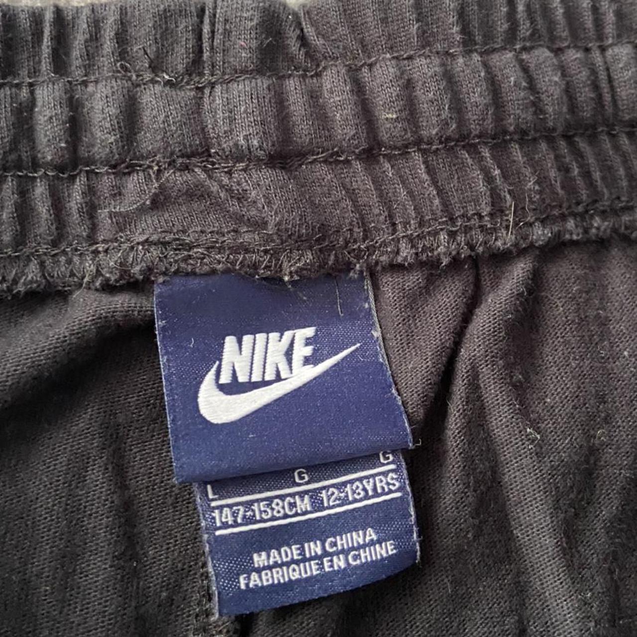 Nike black shorts ,, with a white tick on the... - Depop