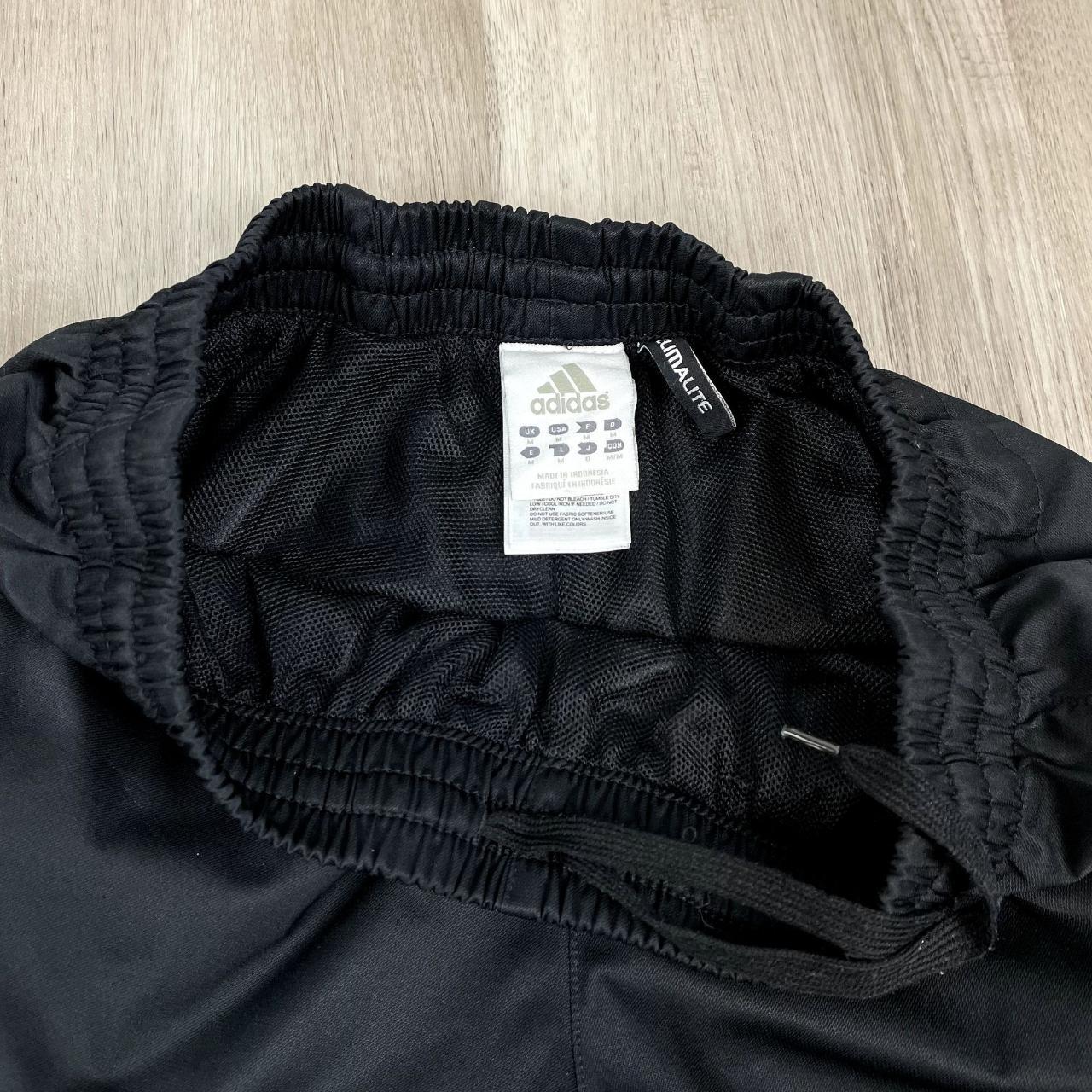 Adidas Climaproof black track pants with embroidered... - Depop
