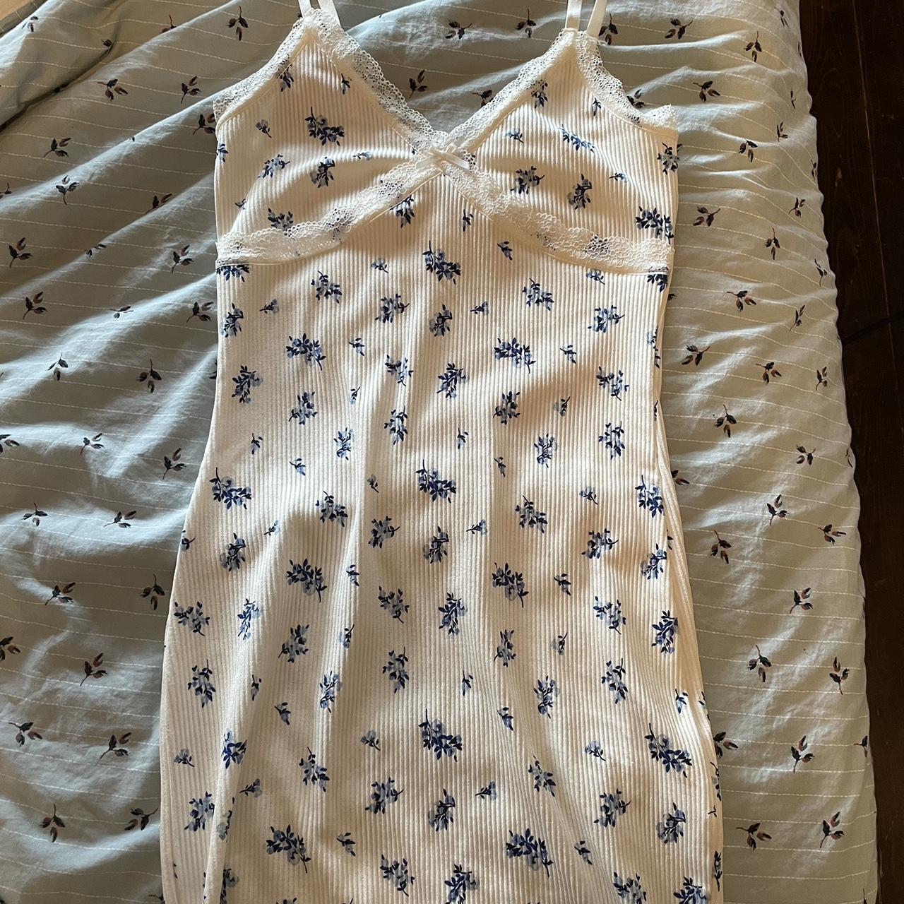 White bodycon mini dress with blue floral flowers.... - Depop