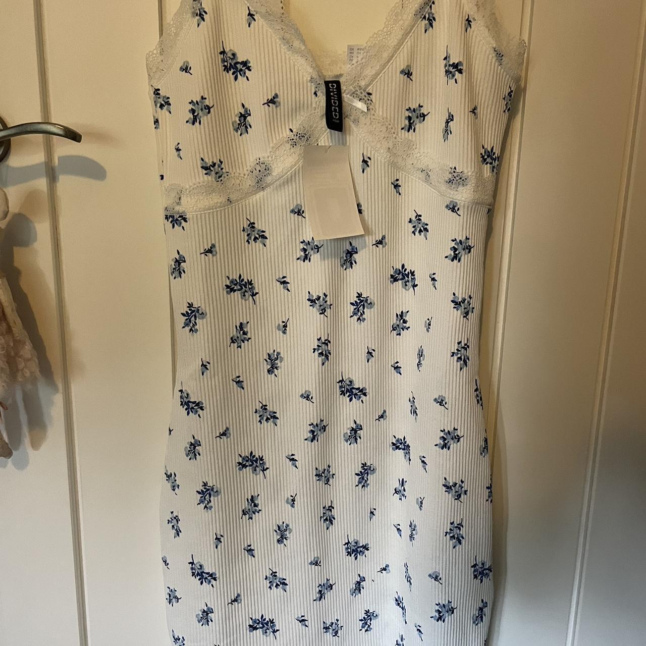 White bodycon mini dress with blue floral flowers.... - Depop