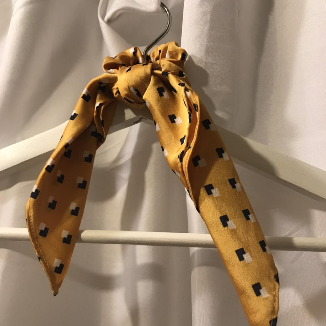 A yellow scrunchie with a black and white polka dot... Depop