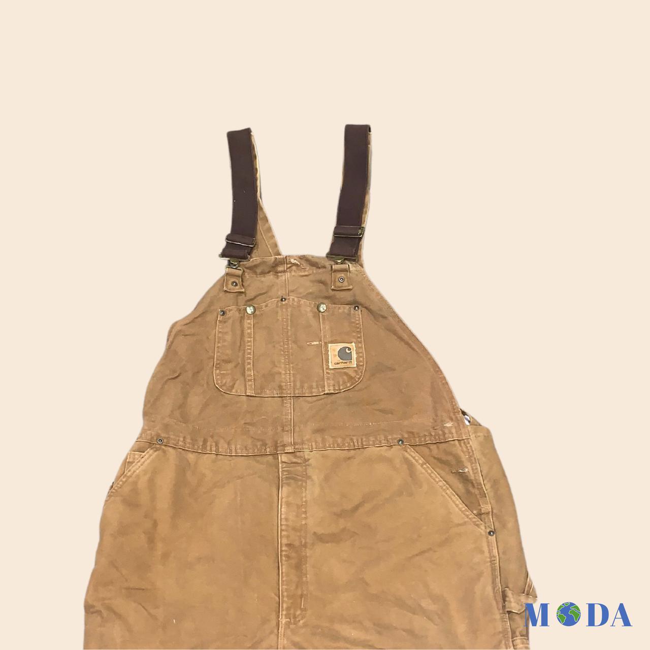 Dark brown Carhartt dungarees with logo... - Depop