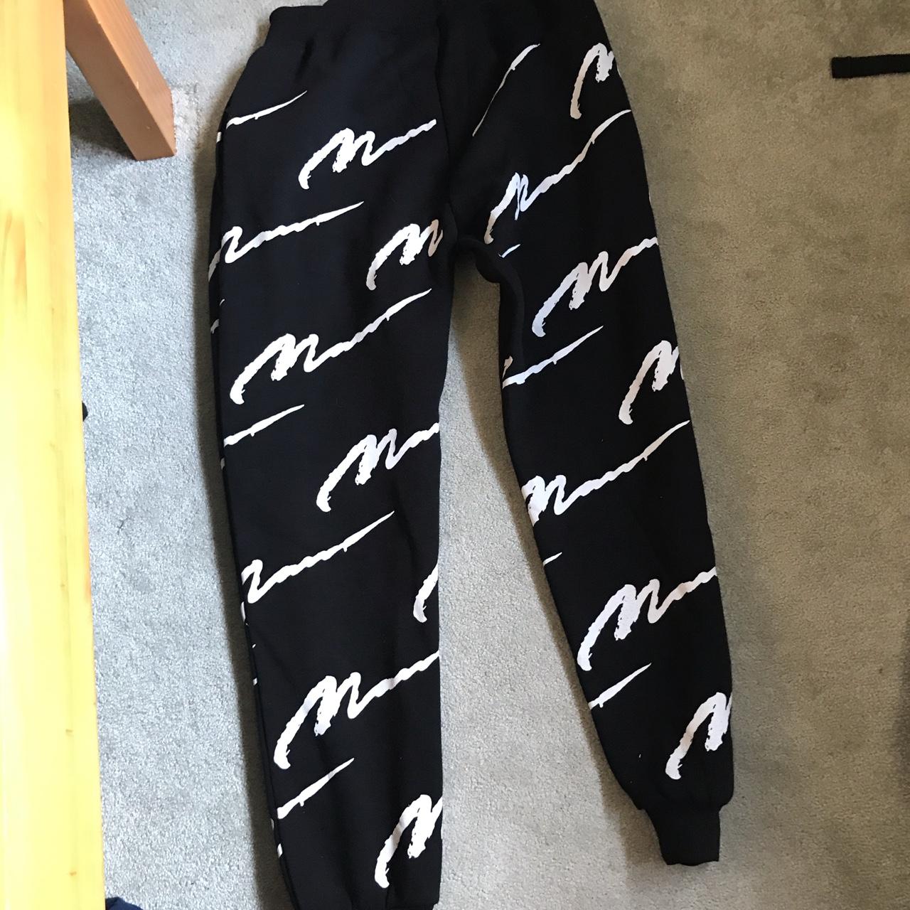 black joggers with white writing