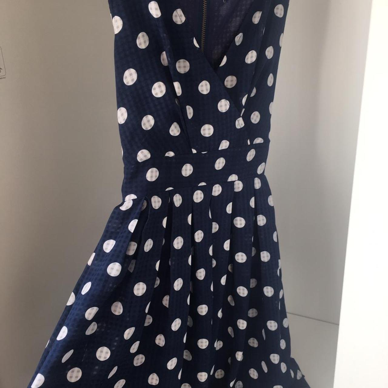 Blue and white polka dot dress with crossover front... - Depop