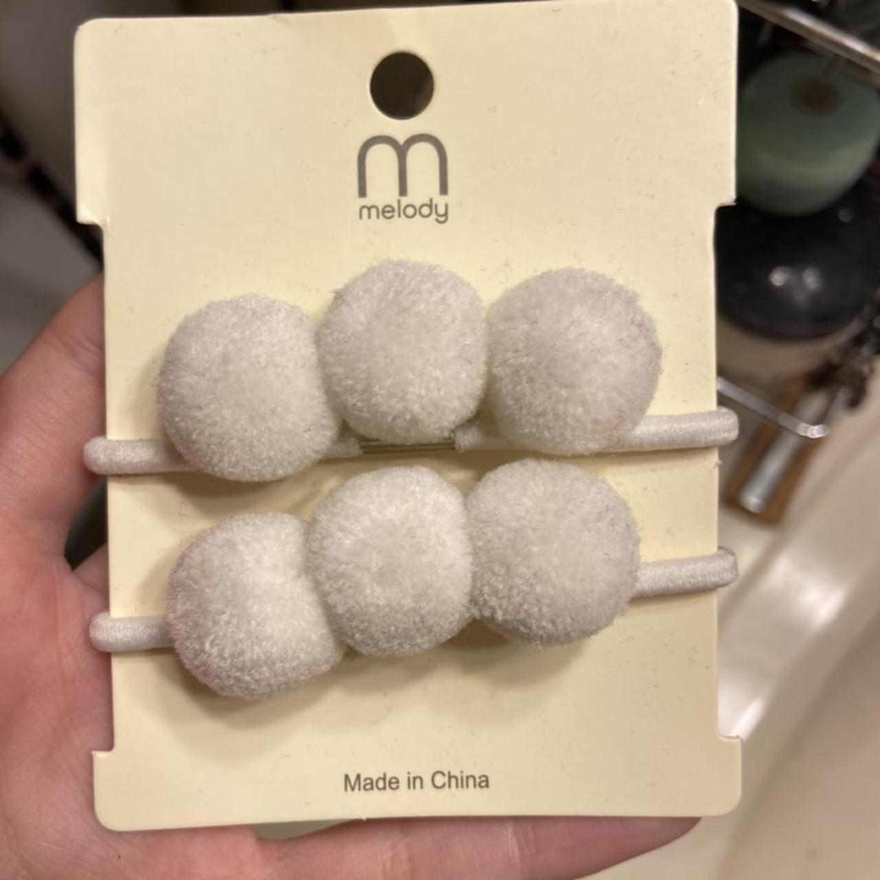 hair ties w/ pom poms never used it just been... Depop