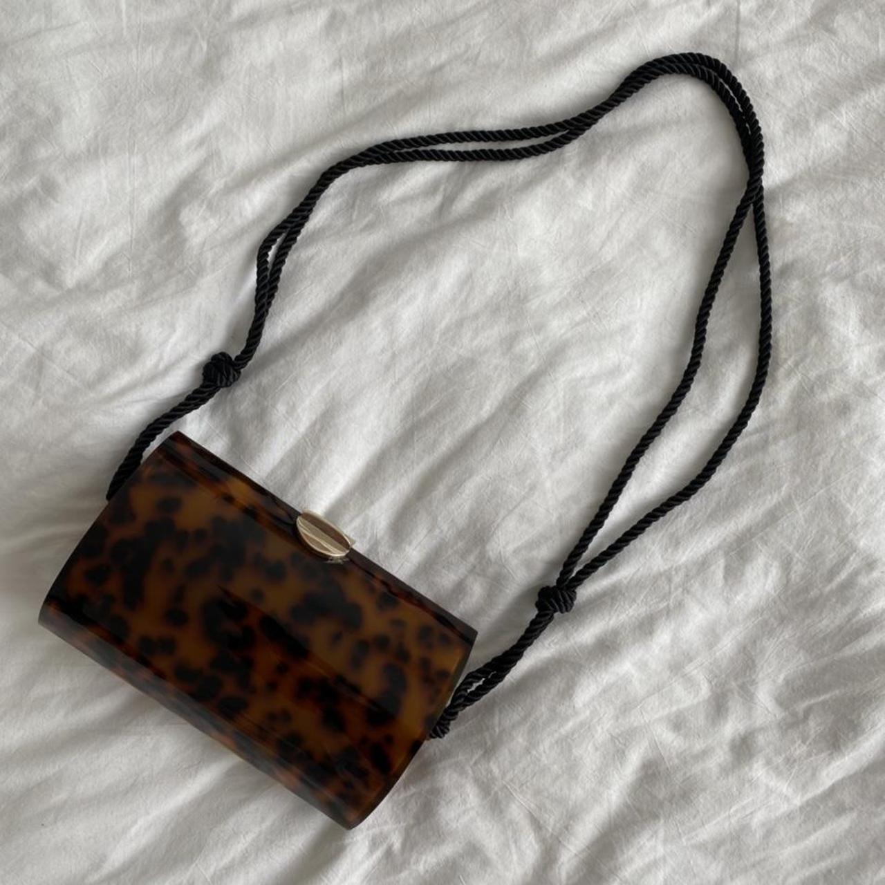 Tortoise shell acrylic clutch bag from Zara with