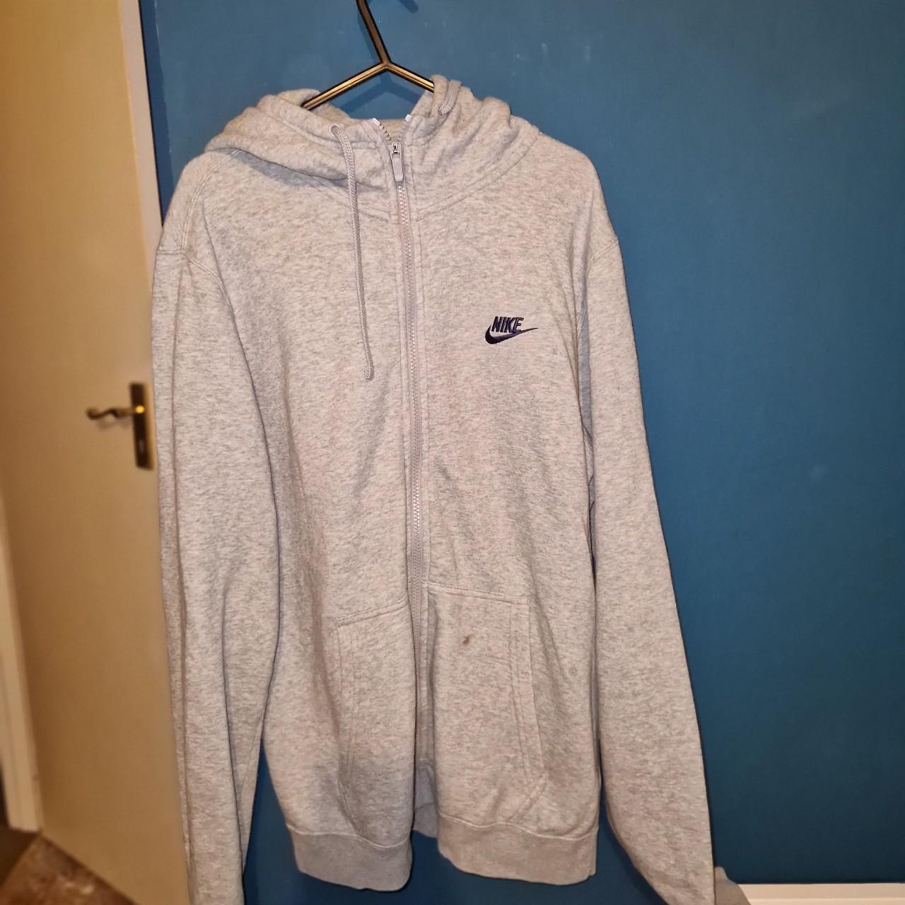 Grey Nike zipup hoodie with blue detailing. Worn a... Depop