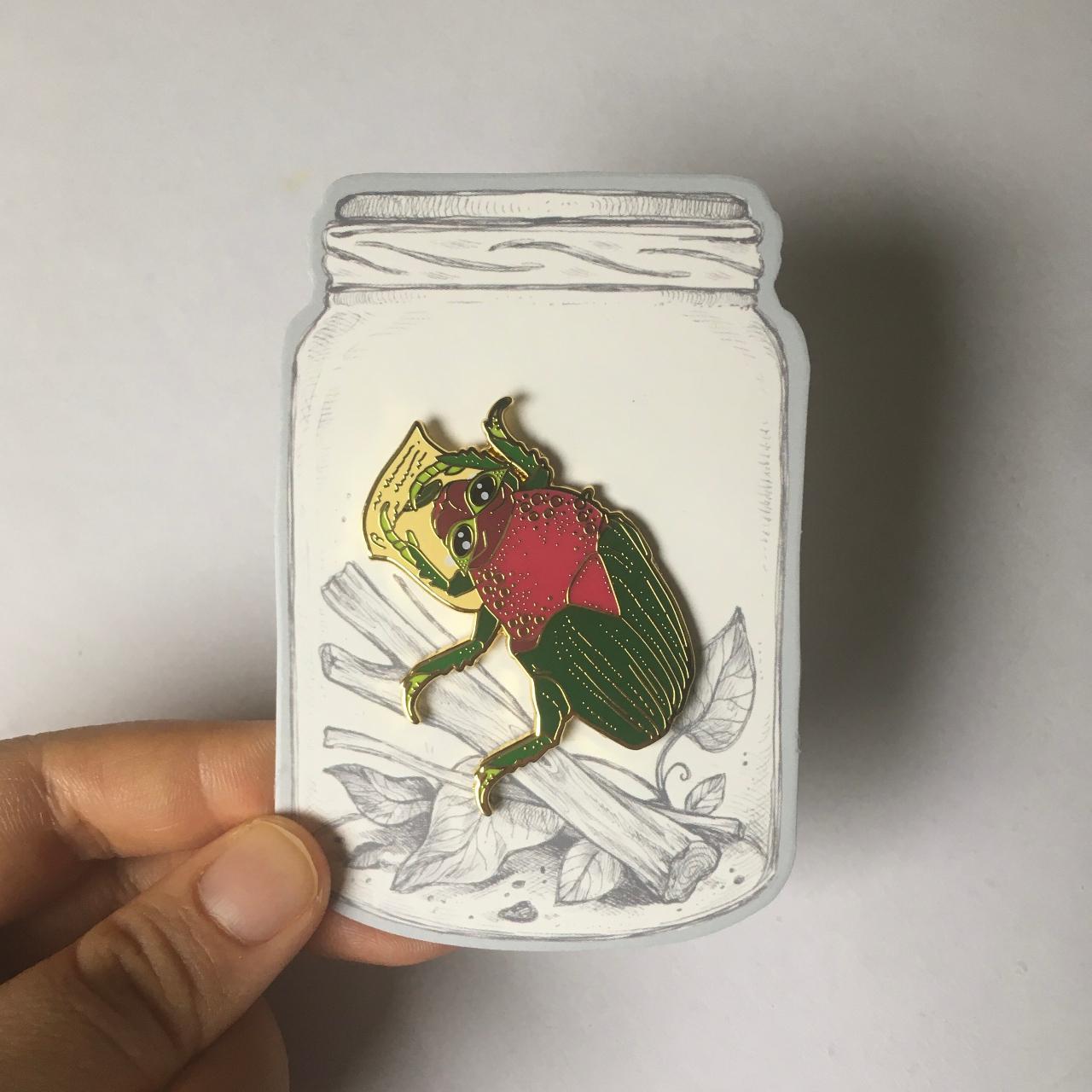 Rita Skeeter beetle enamel pin on backing card from..., image size:1280x1280