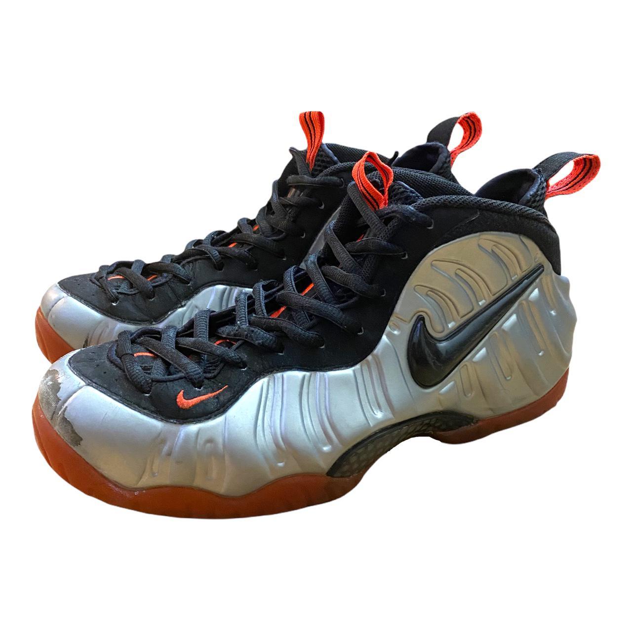 silver and orange foamposites