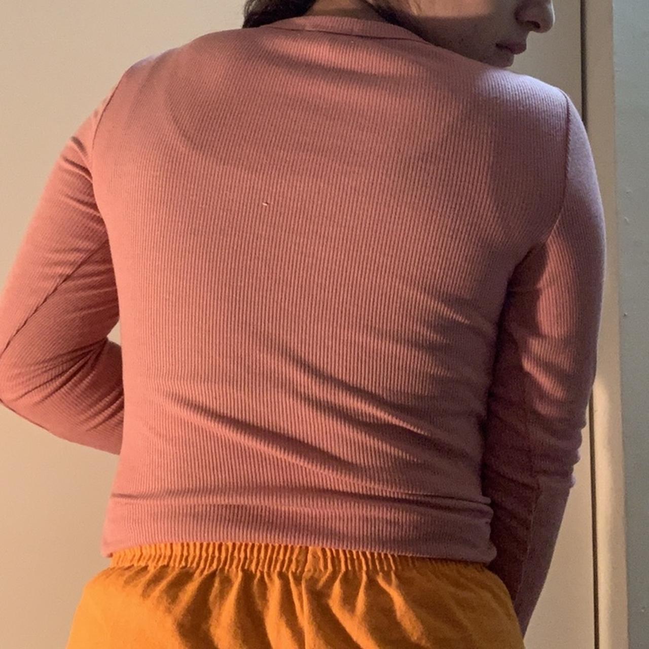 Pink rigid long sleeve top with white daisy at the... - Depop