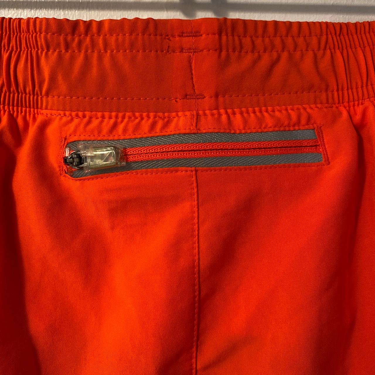 Under Armour neon orange running shorts; NWT;... - Depop