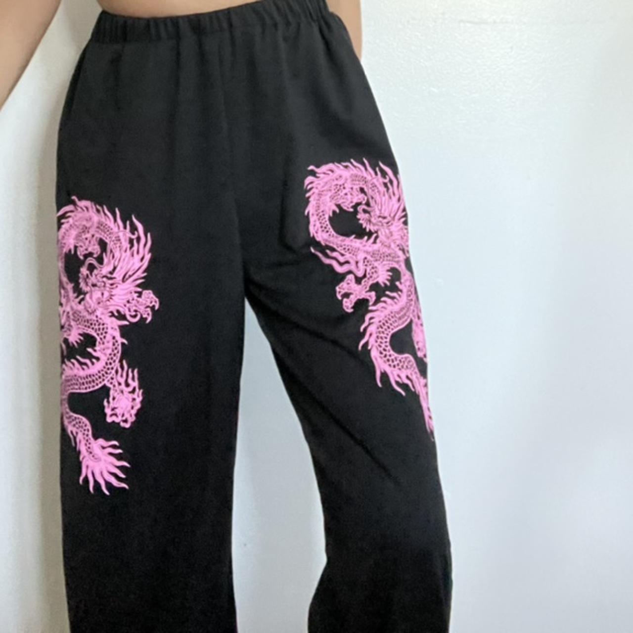 Black thin sweat pants with pink dragons on both