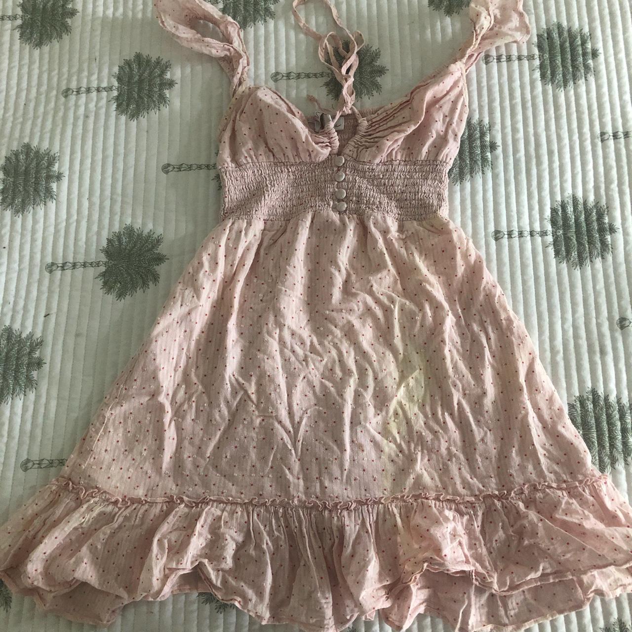 Cute pink polka dot dress. Two bleach stains on her... Depop