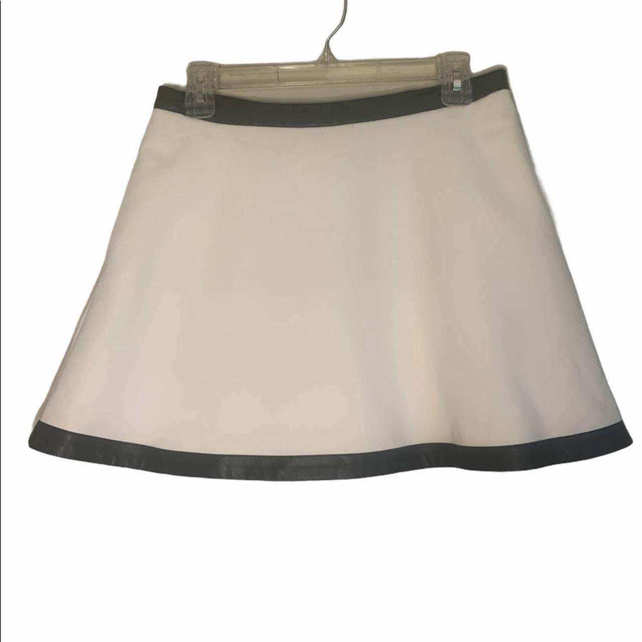 White skirt with black faux leather trim circle