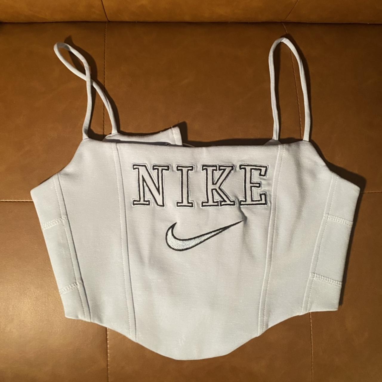 Baby blue Nike corset top with tie closure in back.