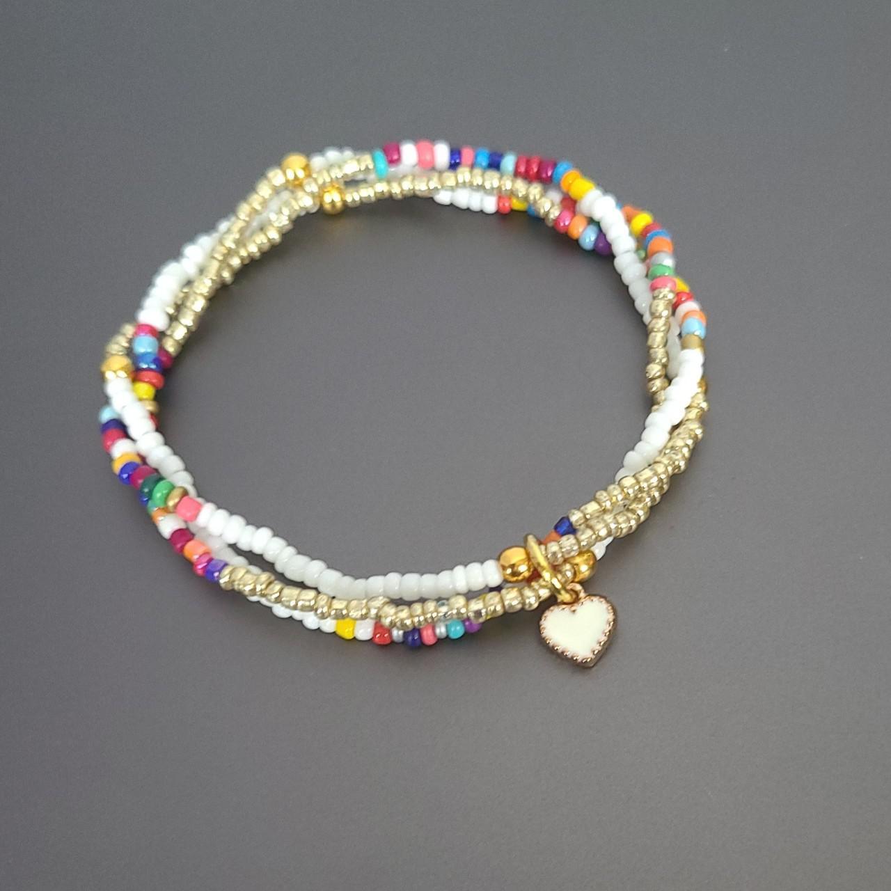 Three stacked beads bracelet with a cute white heart... - Depop