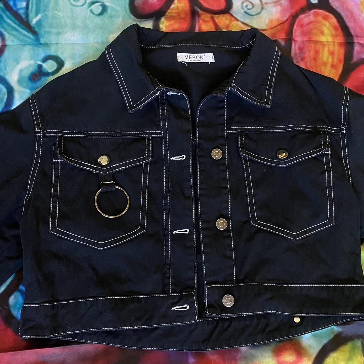 black jean jacket with white stitching